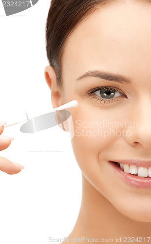 Image of beautiful woman with cotton bud