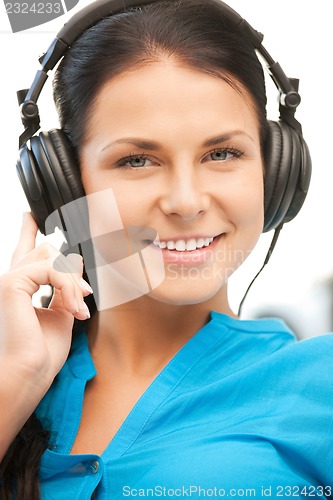 Image of happy teenage girl in big headphones