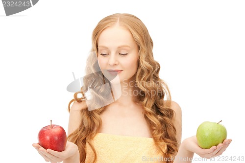 Image of young beautiful woman with green and red apples