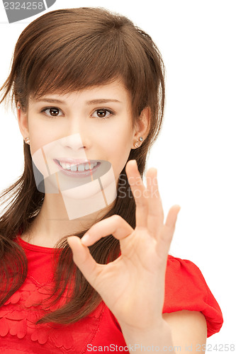 Image of lovely teenage girl showing ok sign