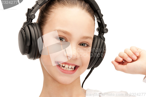 Image of happy teenage girl in big headphones