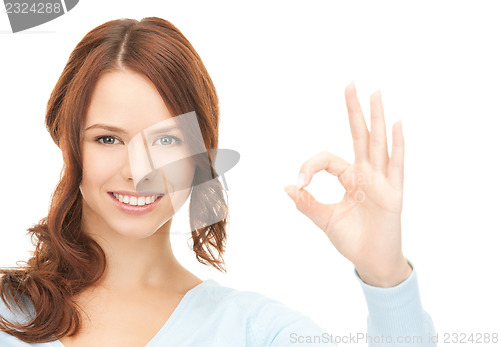 Image of lovely teenage girl showing ok sign
