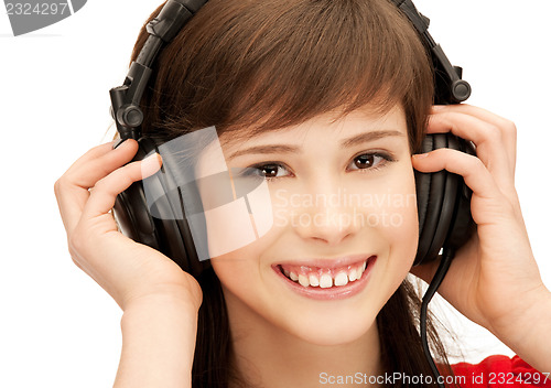 Image of happy teenage girl in big headphones