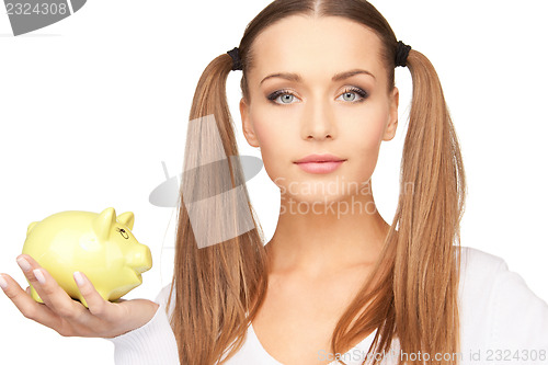 Image of lovely woman with piggy bank