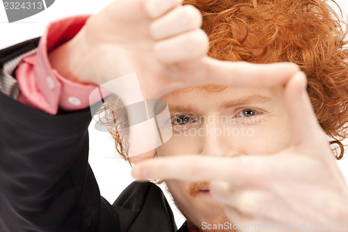 Image of handsome man creating a frame with fingers