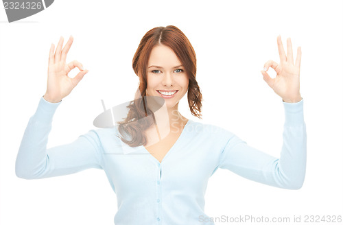 Image of lovely teenage girl showing ok sign