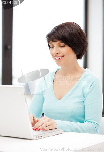 Image of happy woman with laptop computer