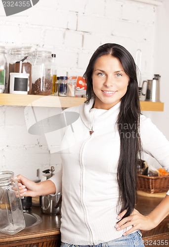 Image of lovely housewife at the kitchen