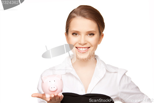 Image of lovely woman with piggy bank