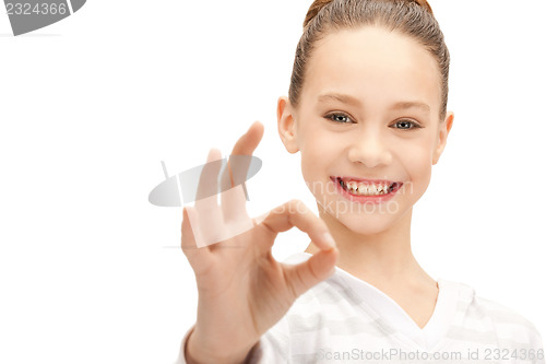 Image of lovely teenage girl showing ok sign