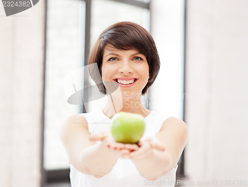 Image of lovely housewife with green apple
