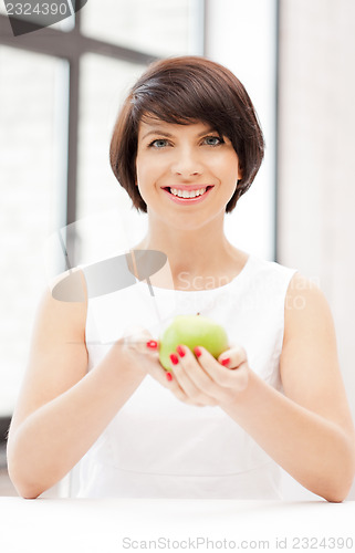 Image of lovely housewife with green apple