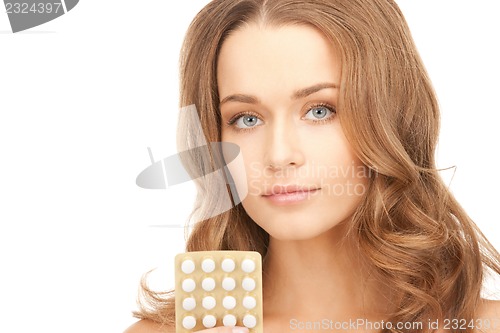 Image of young beautiful woman with pills