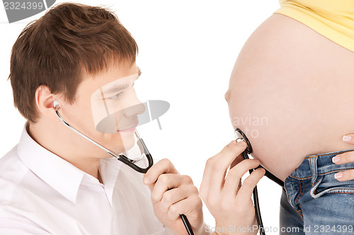 Image of doctor and pregnant woman belly