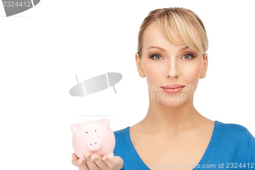 Image of lovely woman with piggy bank