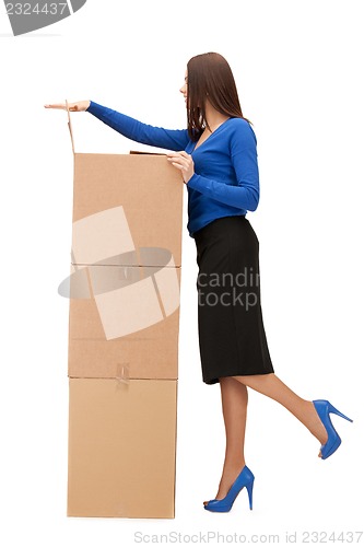 Image of attractive businesswoman with big boxes