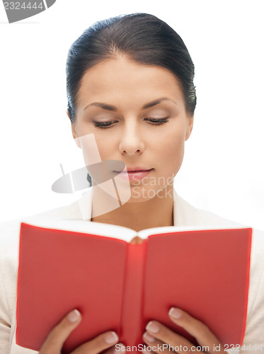 Image of calm and serious woman with book