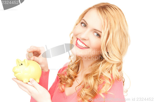 Image of lovely woman with piggy bank and money