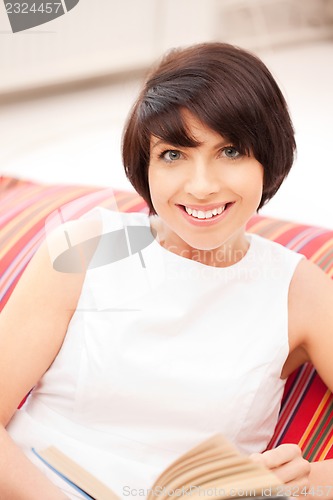 Image of happy and smiling woman with book