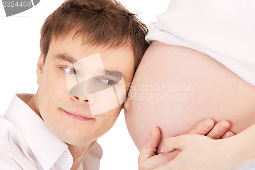 Image of male face and pregnant woman belly