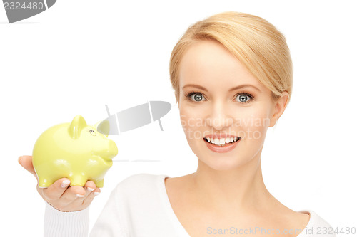 Image of lovely woman with piggy bank