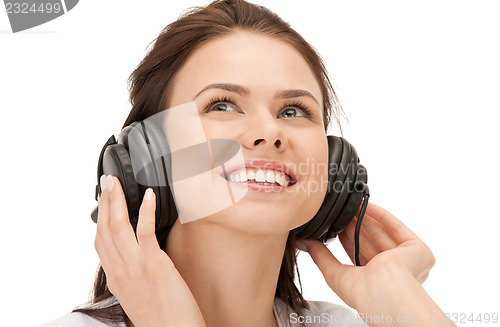 Image of happy teenage girl in big headphones