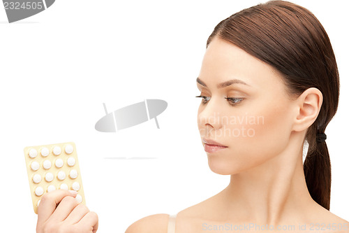 Image of young beautiful woman with pills