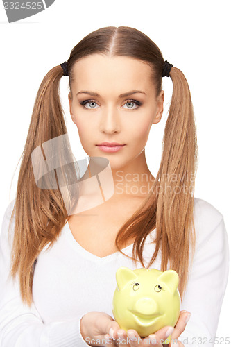 Image of lovely woman with piggy bank