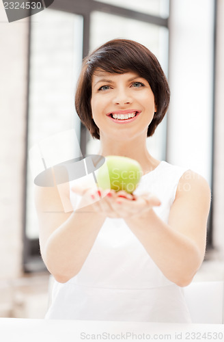 Image of lovely housewife with green apple