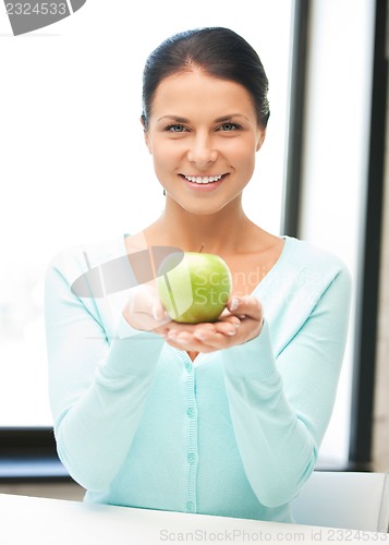 Image of lovely housewife with green apple