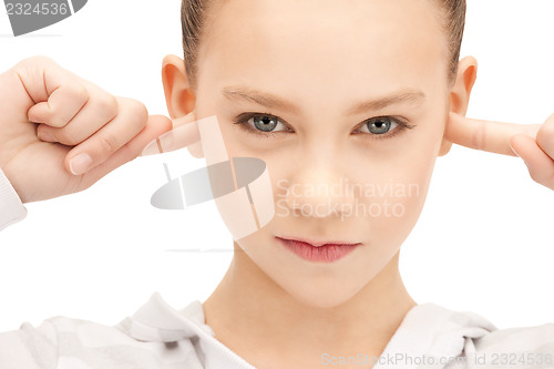 Image of teenage girl with fingers in ears