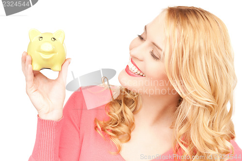 Image of lovely woman with piggy bank