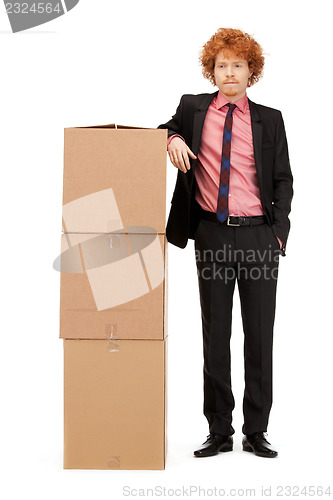 Image of attractive businessman with big boxes