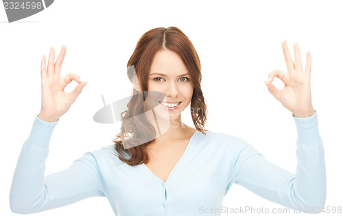 Image of lovely teenage girl showing ok sign