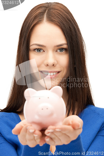 Image of lovely woman with piggy bank