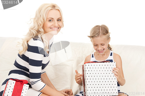 Image of mother and little girl with gifts