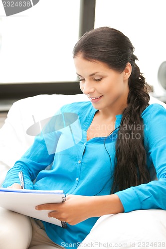 Image of happy woman with big notepad