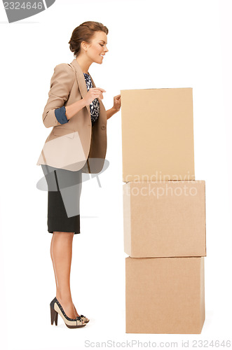 Image of attractive businesswoman with big boxes