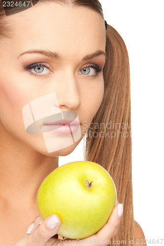 Image of young beautiful woman with green apple