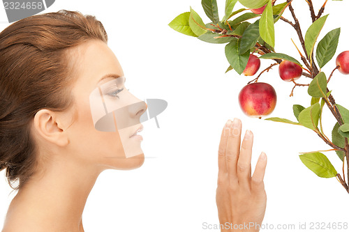 Image of lovely woman with apple twig