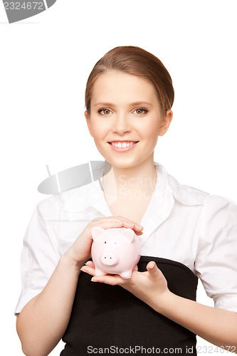 Image of lovely woman with piggy bank