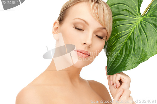 Image of woman with green leaf