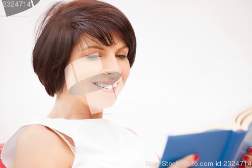 Image of happy and smiling woman with book