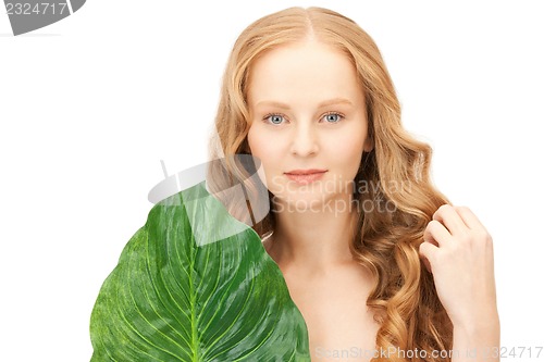 Image of woman with green leaf
