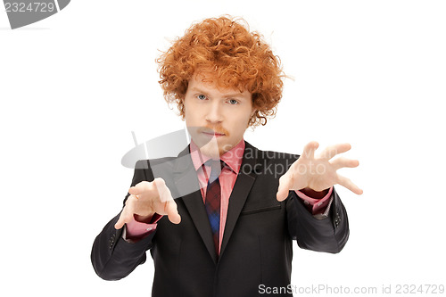 Image of businessman working with something imaginary