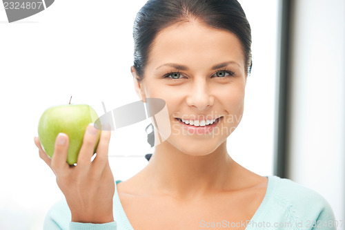 Image of lovely housewife with green apple