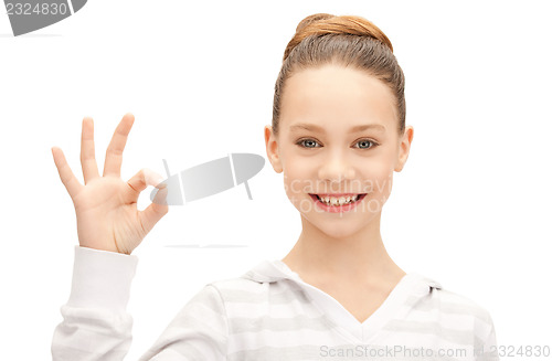 Image of lovely teenage girl showing ok sign