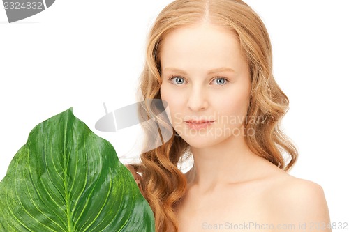 Image of woman with green leaf
