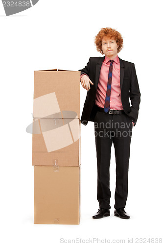 Image of attractive businessman with big boxes