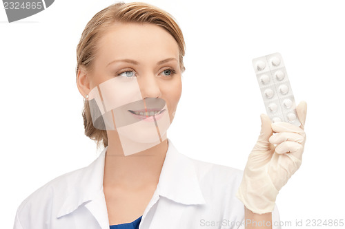 Image of attractive female doctor with pills